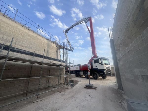 Concrete pump truck feeding a pour